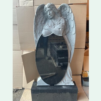 Памятник со скульптурой ангела обнимающего овальный памятник